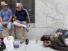 Special effects make-up artists Gino Crognale and Andy Schoenberg relax next to some of their handiwork on the street in downtown Atlanta, "The Walking Dead" June 14, 2011