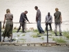 Extras stumble and lurch through a zombie walking scene, "The Walking Dead" June 14, 2011
